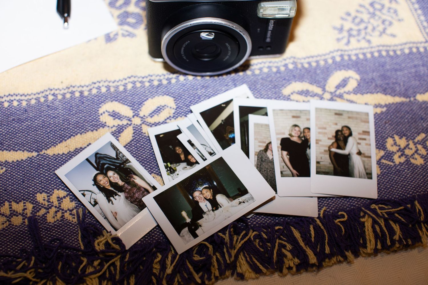Black and white wedding photos laid out in a row on a dark surface.