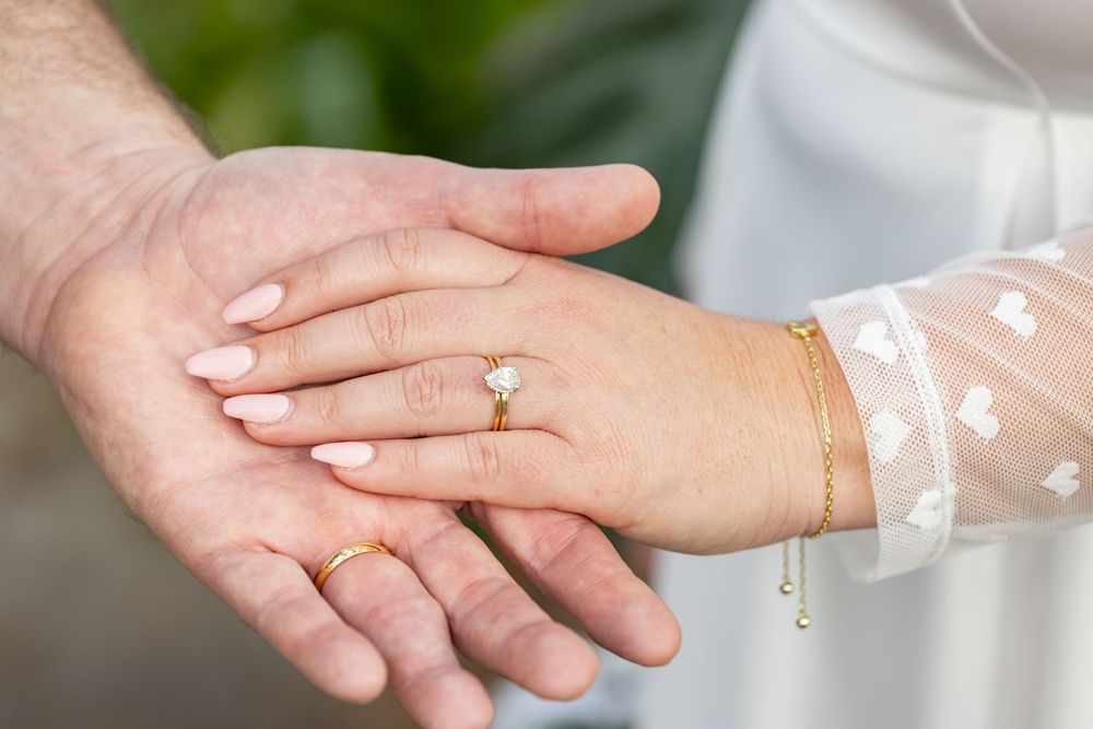 A series of hands with hospital bracelets showing a progression of medical care and healing journey.