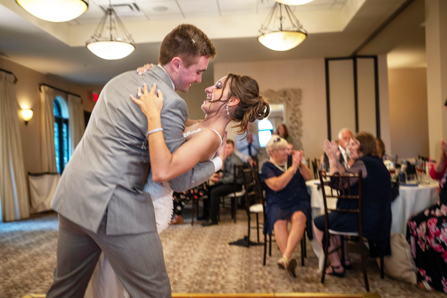 A couple shares their first dance at a wedding reception in the club at corazon