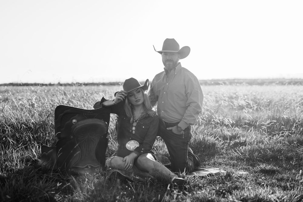Black and white panoramic series of cowboys working in a vast open field.
