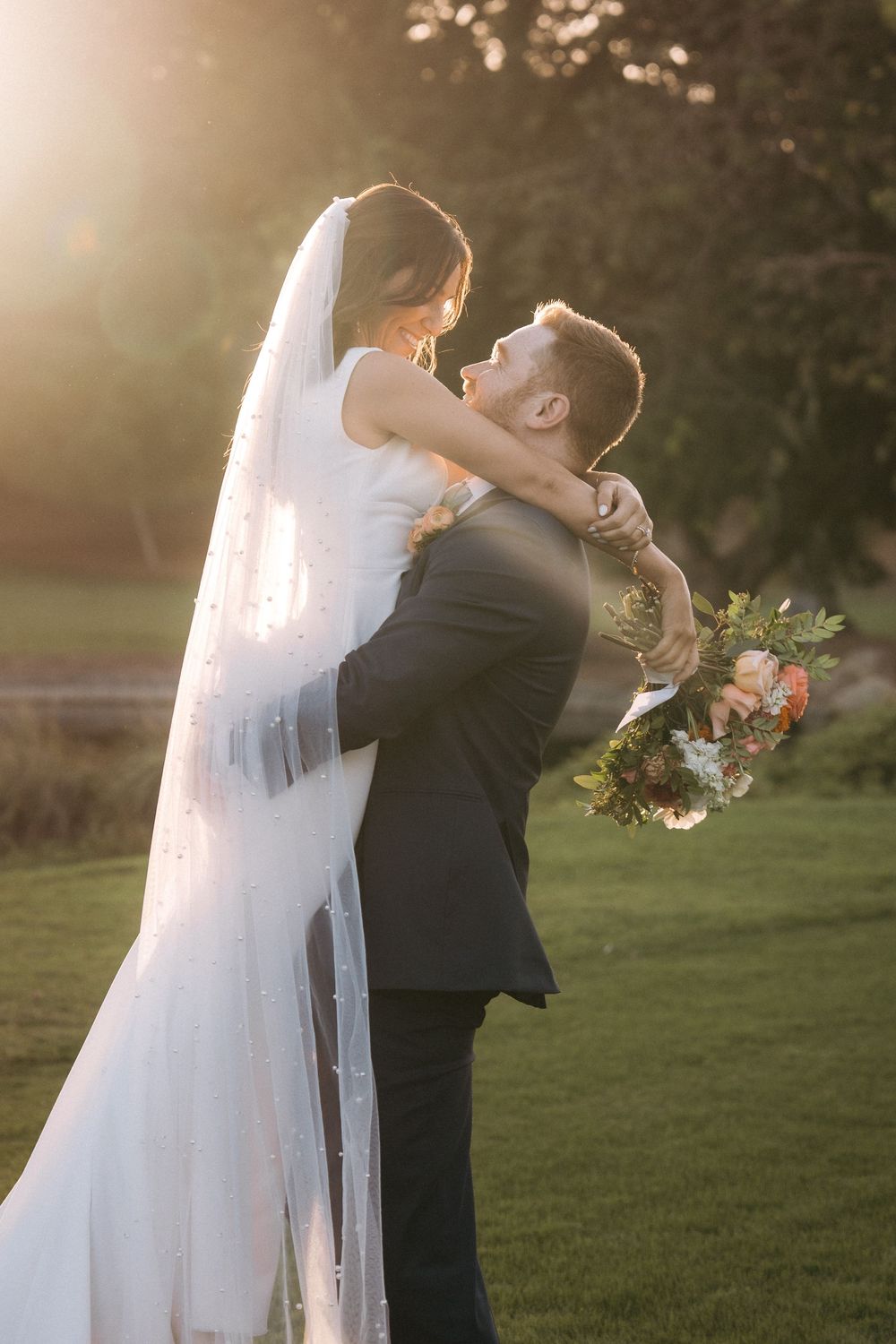 A romantic sunset wedding photo series shows a couple in traditional attire sharing intimate moments on a grassy lawn.