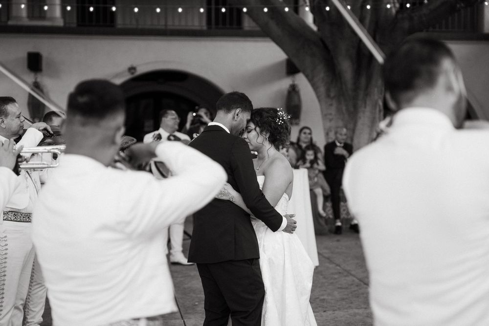 Wedding guests dance and celebrate together on the dance floor during an evening reception.