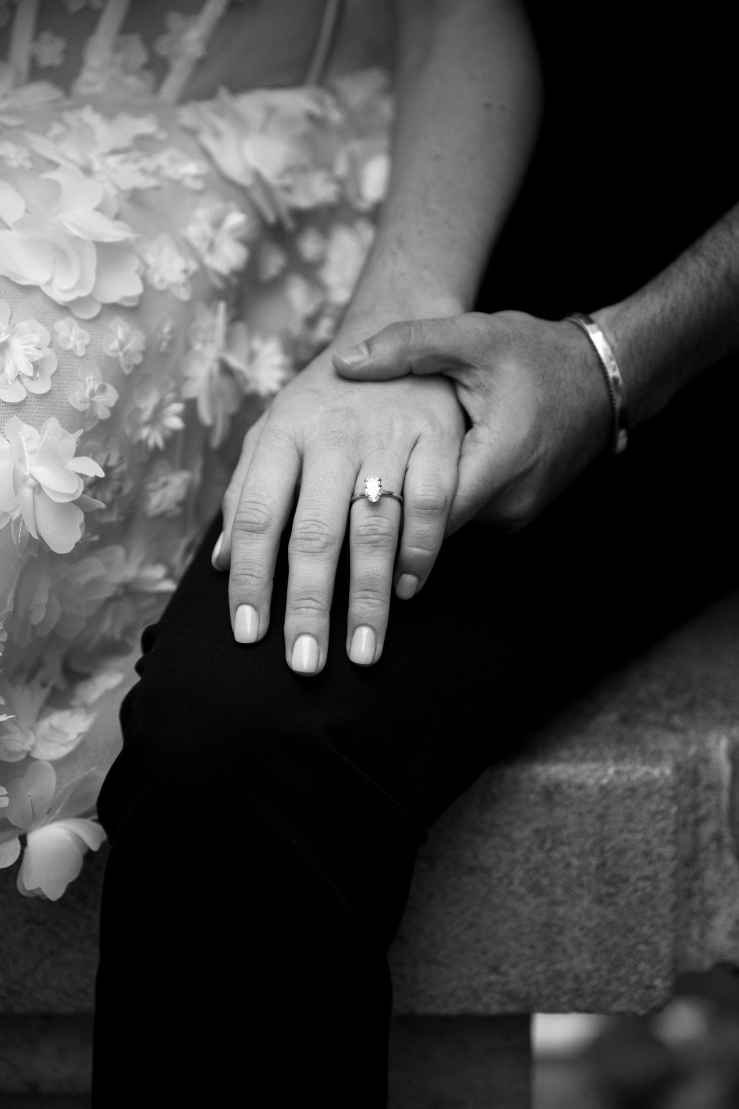 A black and white series of wedding ring close-ups showing hands with engagement rings against a dark background.