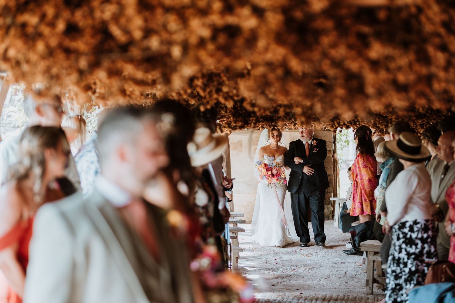 Wedding couple shares a romantic first dance under warm glowing lights at an elegant wedding at Lyde Court, Hereford.