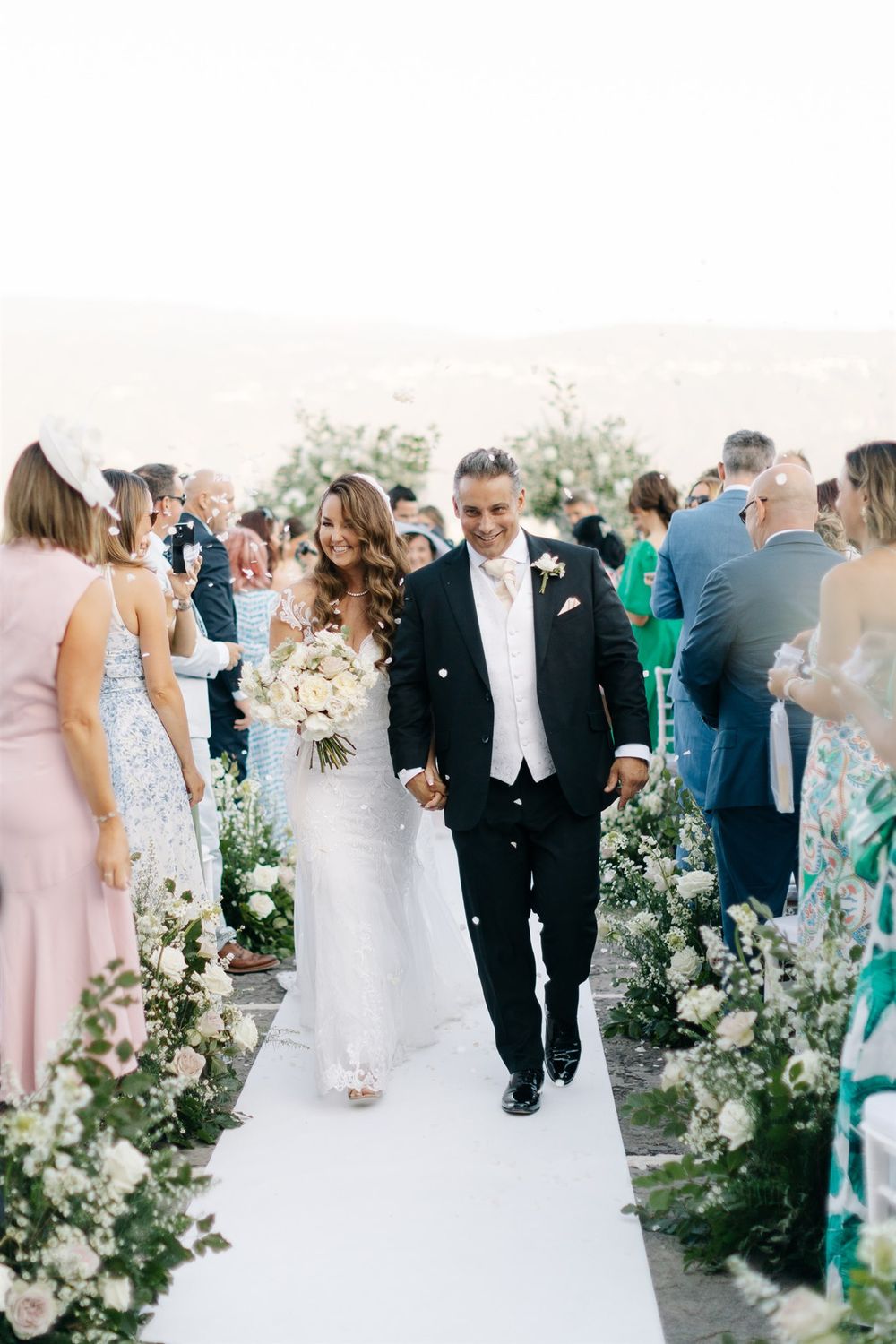 Newly married couple celebrating after their ceremony overlooking Lake Garda