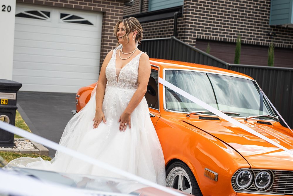 Bride with orange muscle car