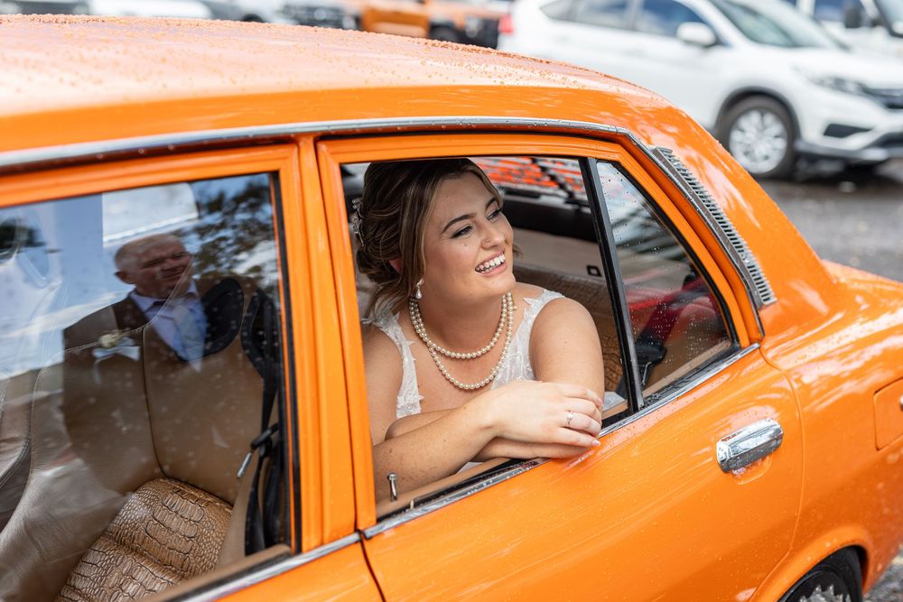 Bride with orange muscle car