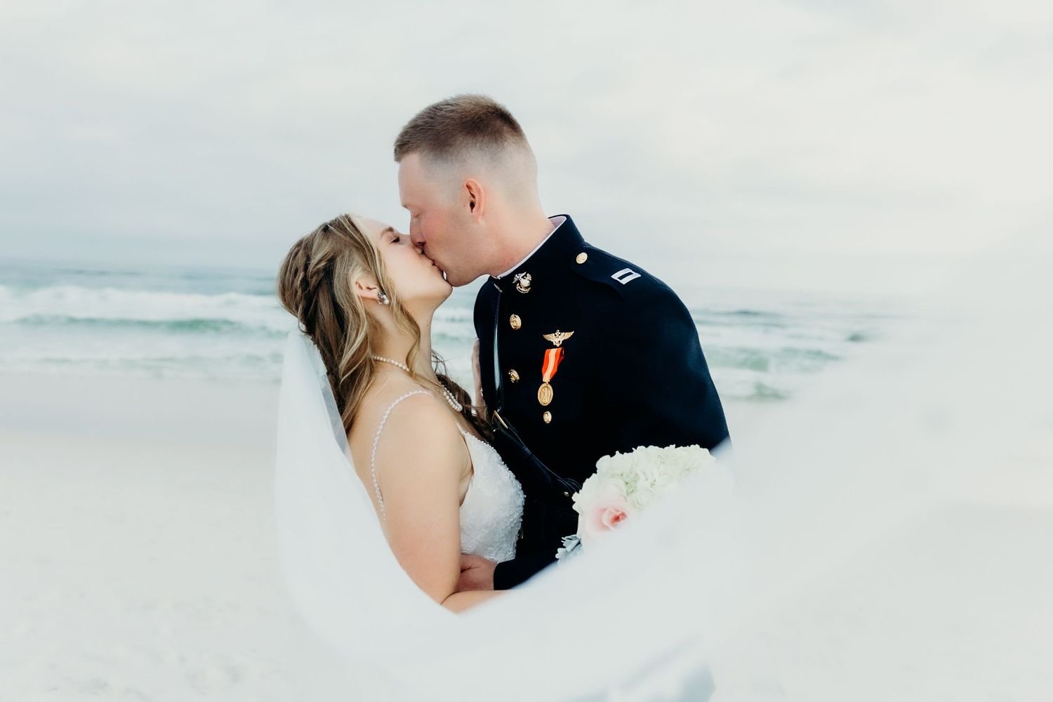 Romantic beach scene with waves crashing on shore in soft lighting.