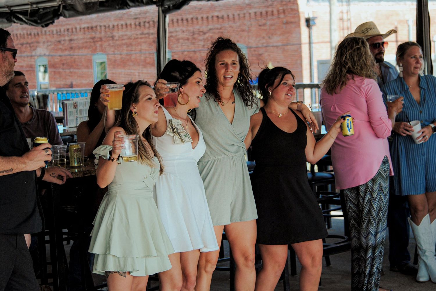 People dancing and celebrating together at a social gathering in a casual indoor setting.