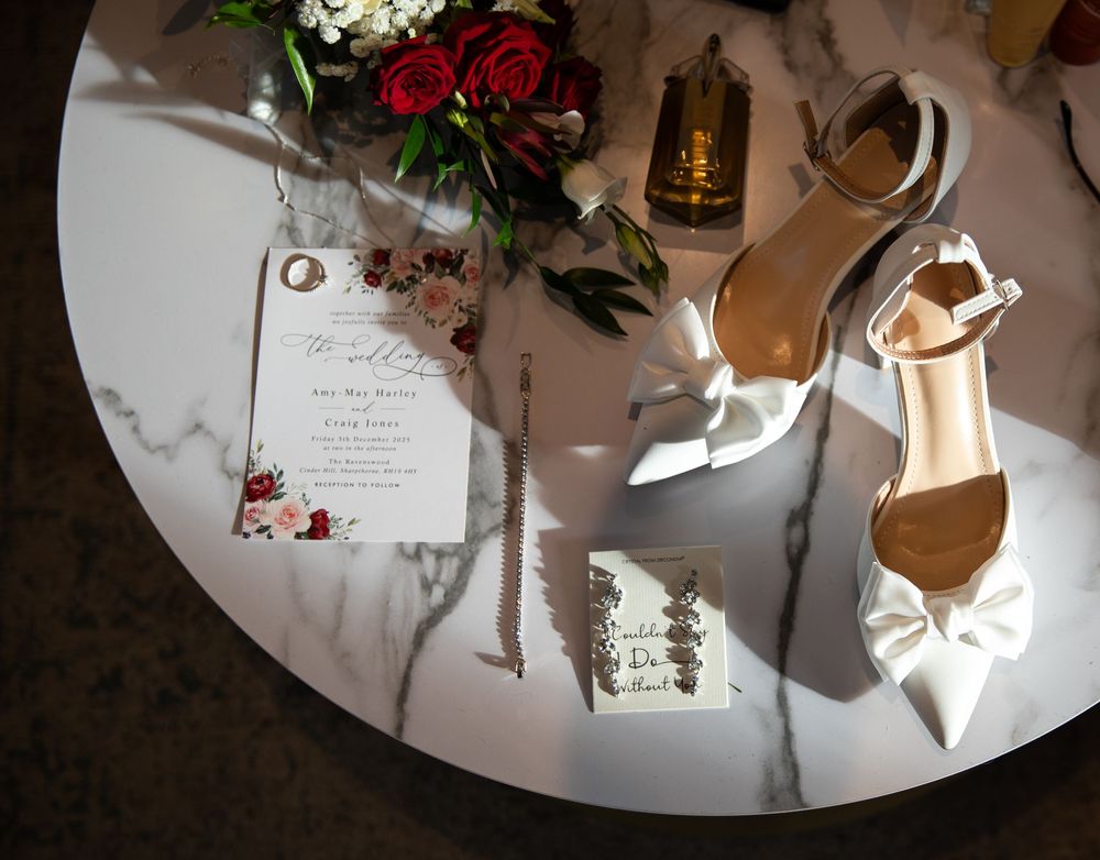 Elegant wedding reception decor with white floral arrangements and candlelit tables in a formal dining setting.