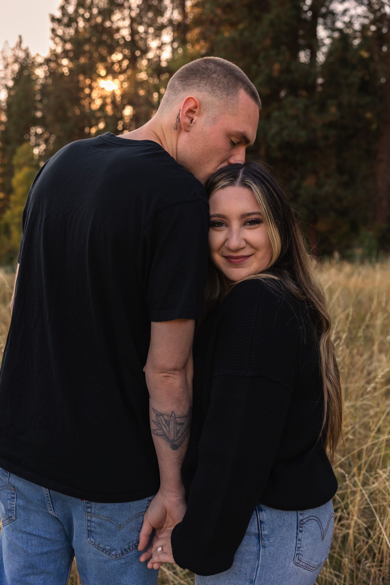 A couple shares intimate moments in a field at sunset, captured in a series of romantic poses.