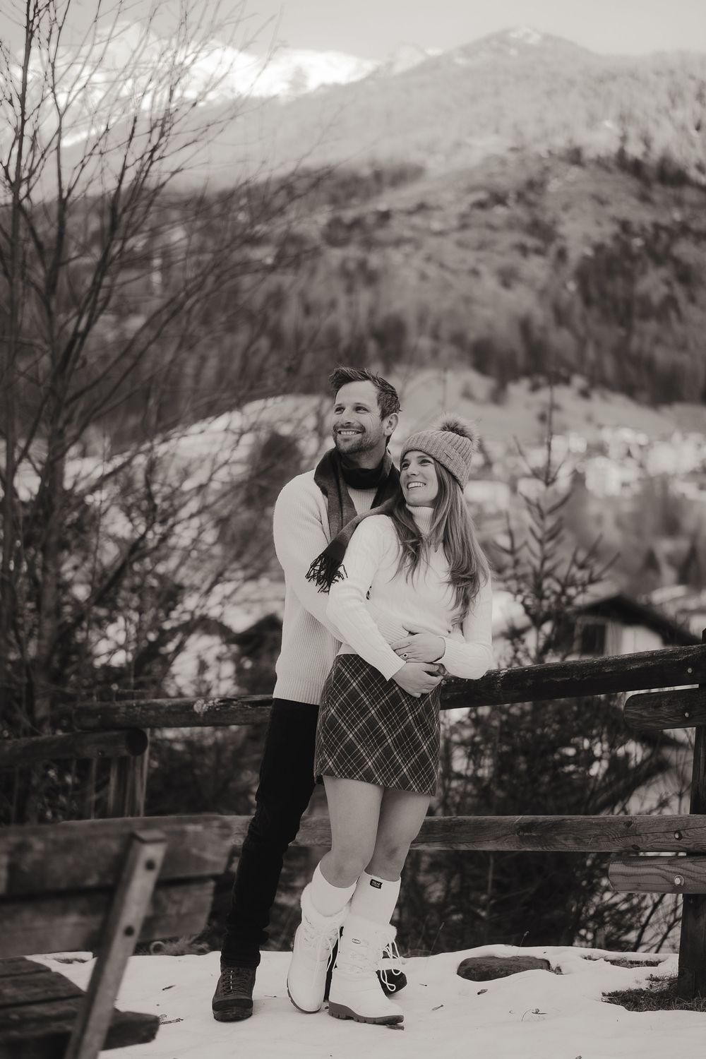 Spontaneous couple hugging tightly, feeling completely at ease in a vast mountain landscape.