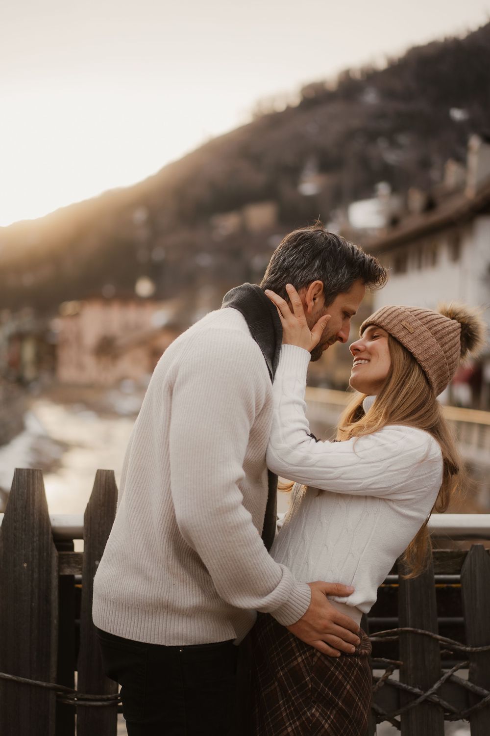 Epic wide shot of a romantic couple standing on a mountain ridge in the Dolomites, Italy.