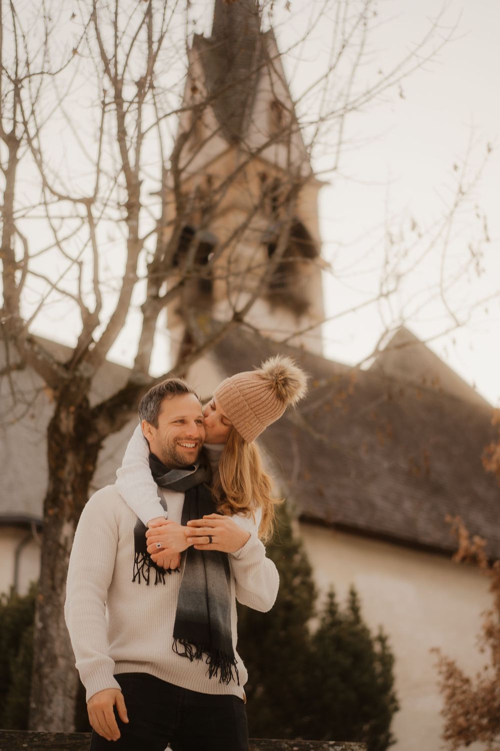Destination wedding photographer capturing a couple embracing against a majestic mountain backdrop.