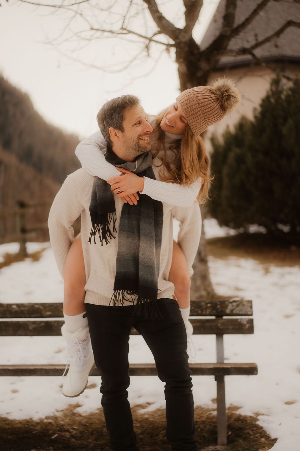 Intimate portrait of a deeply in love American couple whispering secrets in the mountains.