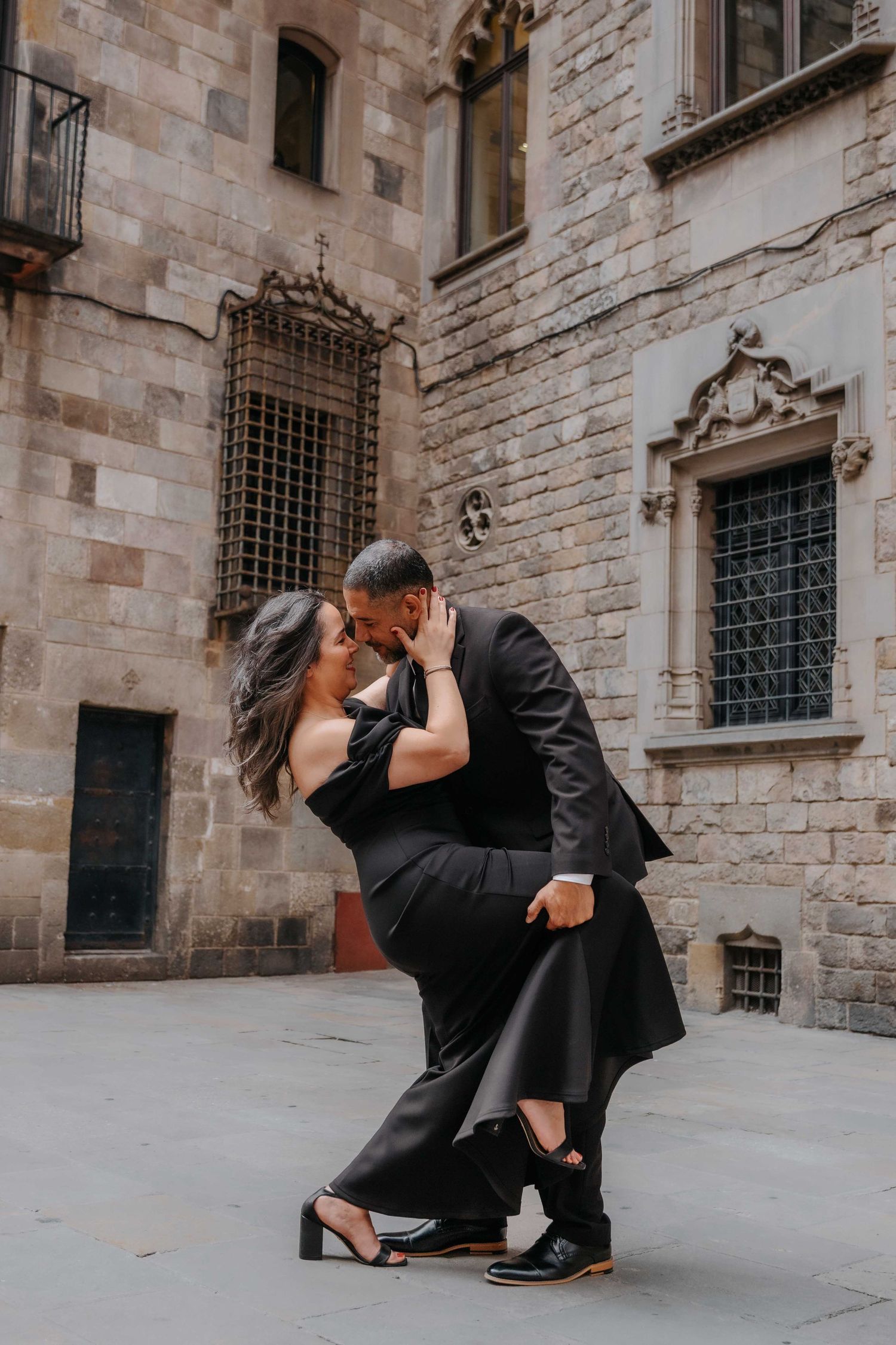 Marilyn and Armando holding hands walking through Barcelona Old City October morning.