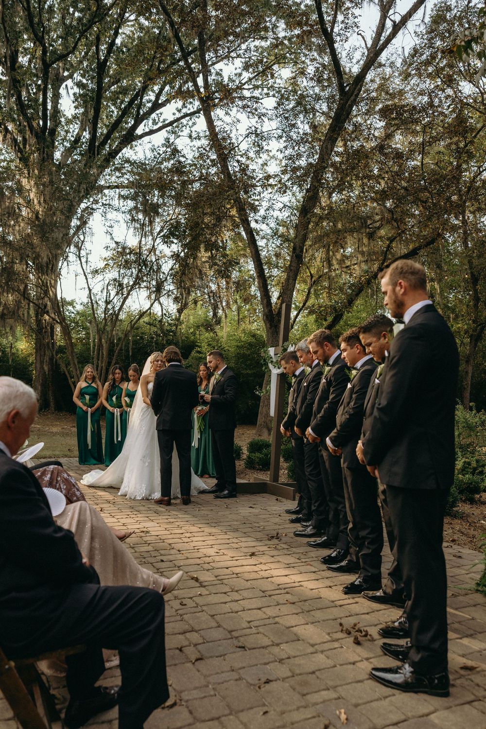 An outdoor wedding ceremony under the trees at The Elms of Coosada