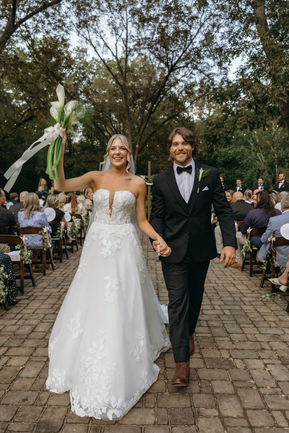 Bride and groom exiting outdoor wedding ceremony at The Elms of Coosada in Coosada, Alabama