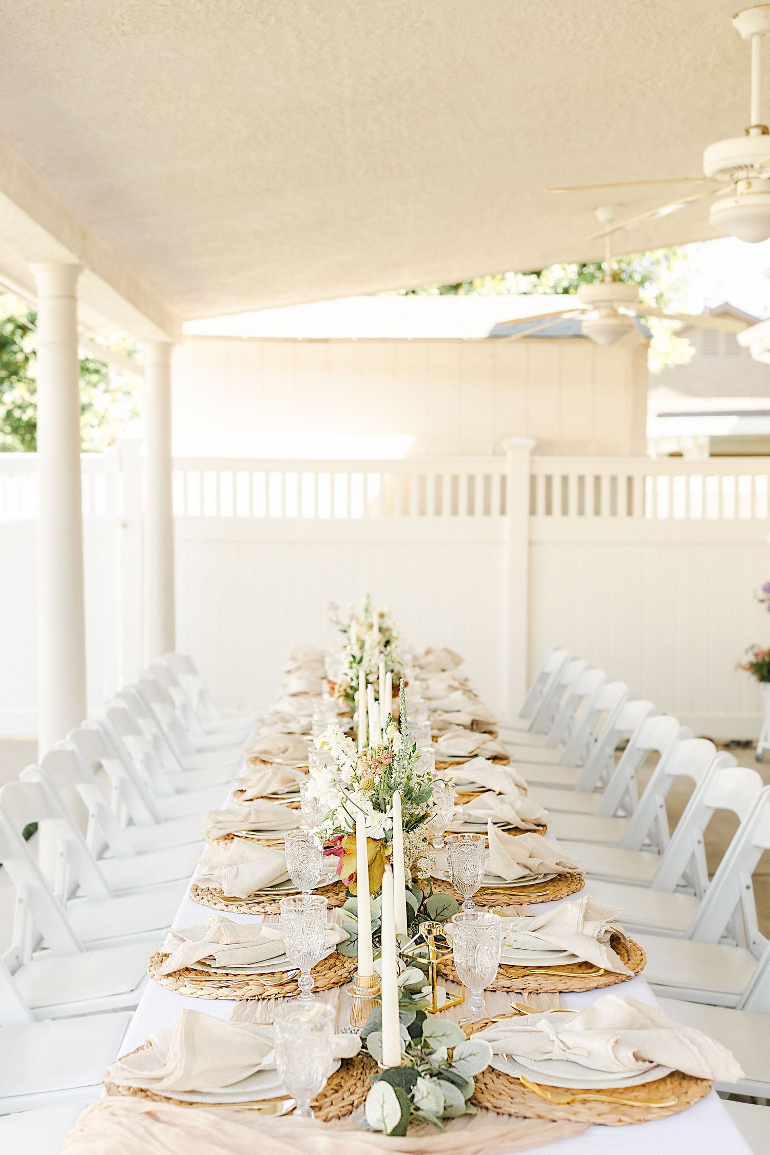 Elegant white Bay Area floral baby shower table setting with woven chargers, floral centerpieces photographed by Chelsee Rawe Photography