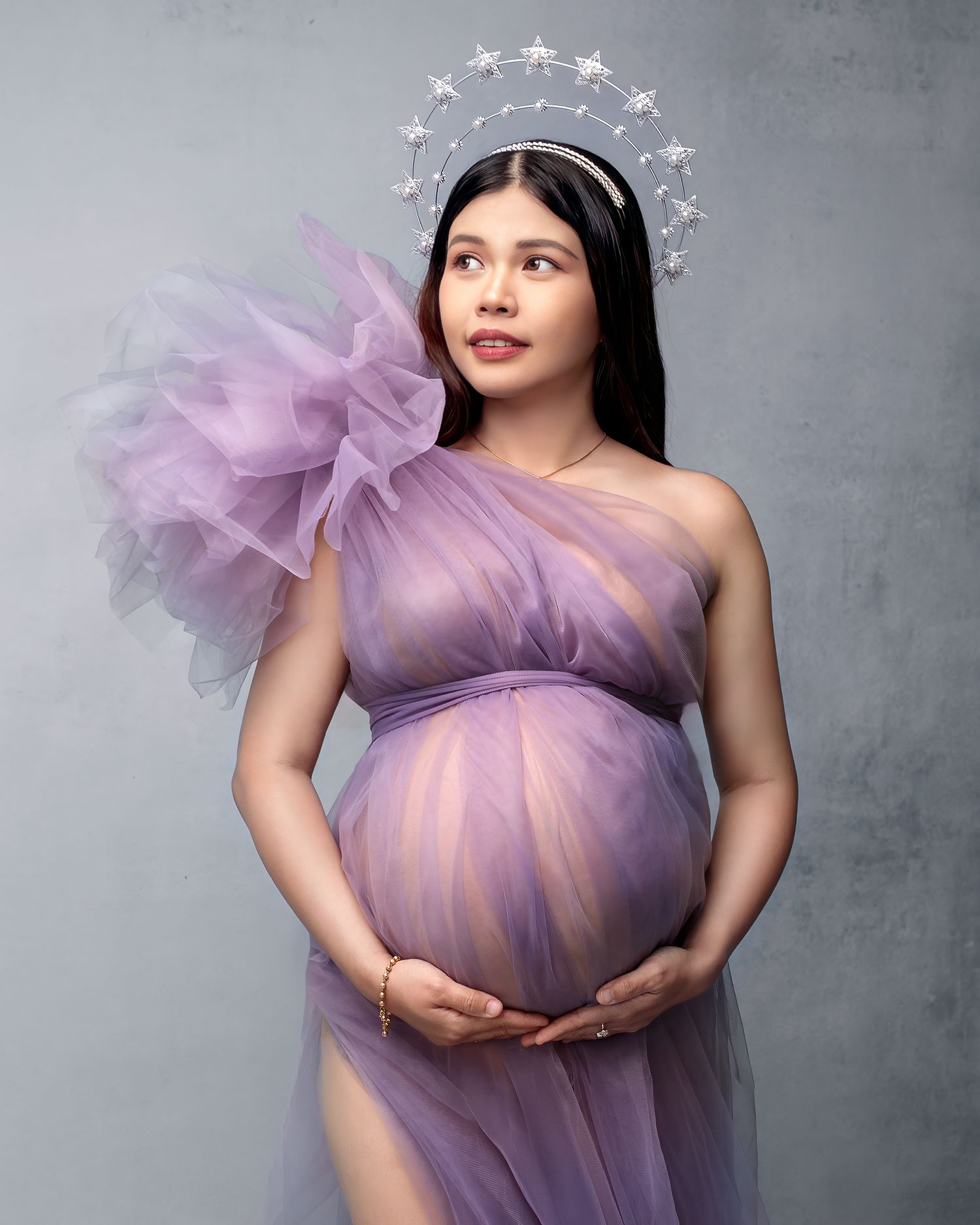 Close-up pregnancy portrait of a woman in a beautiful silver star halo crown.