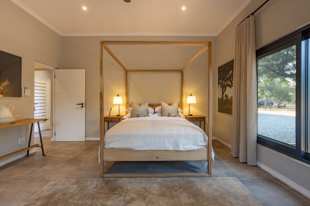 Elegant master bedroom with en-suite bathroom and balcony view