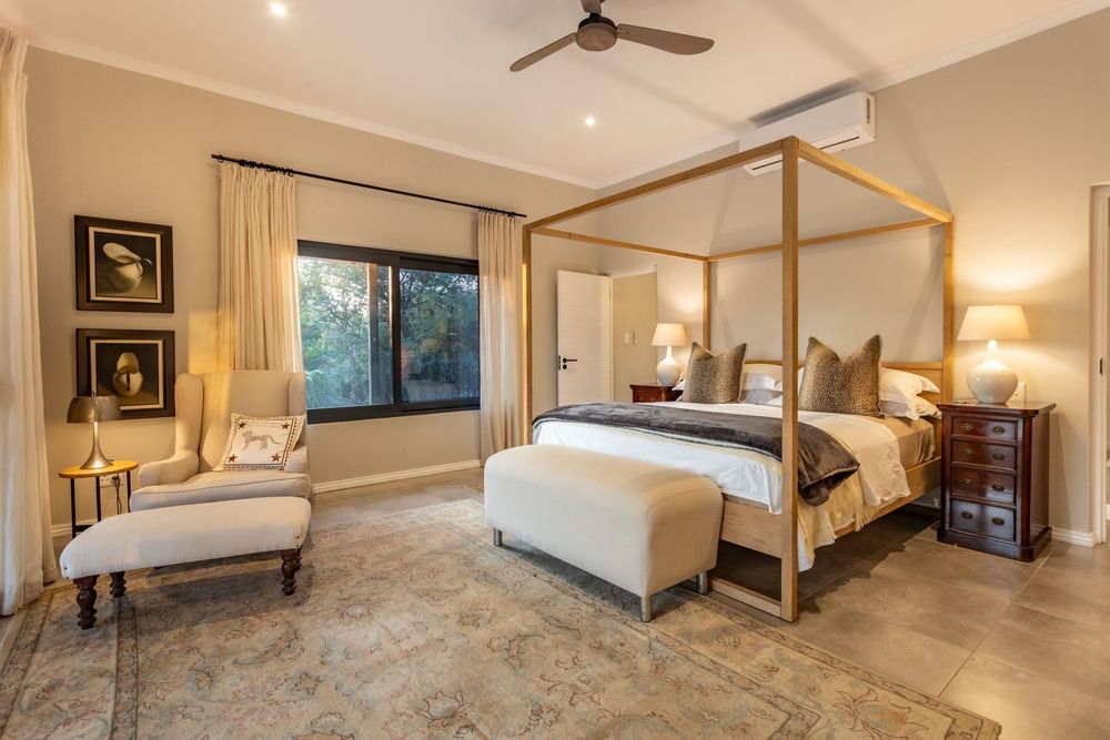 Elegant master bedroom with en-suite bathroom and balcony view