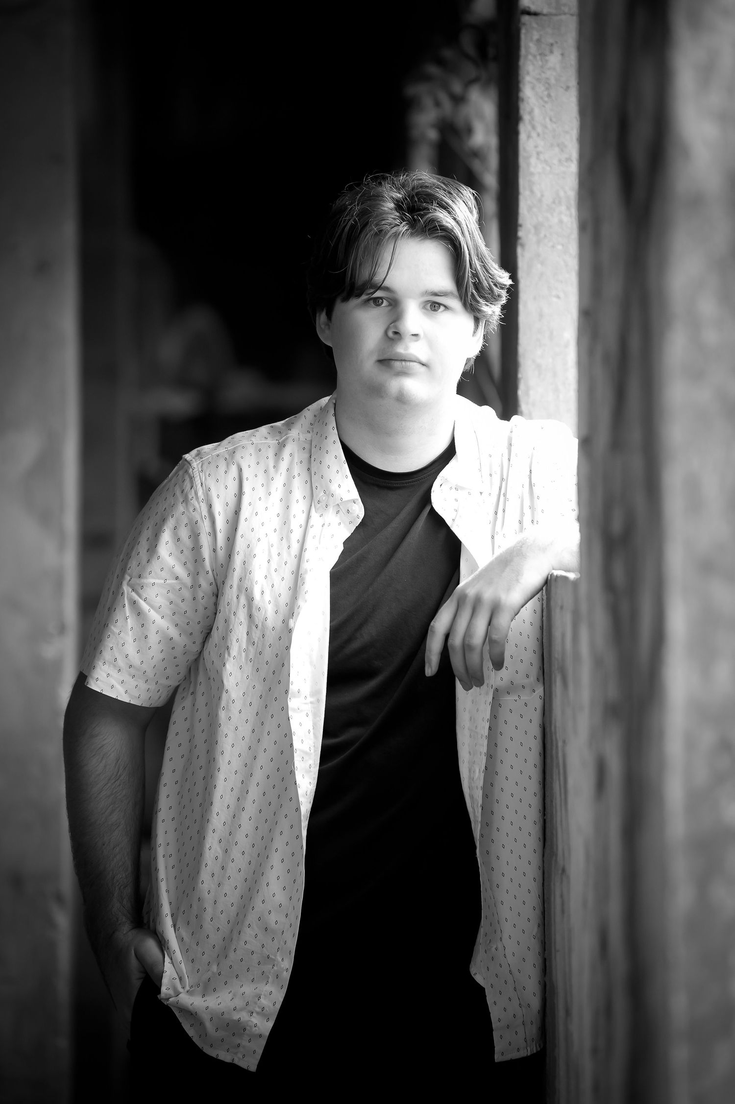 Black and white portrait series with dramatic lighting and white shirt.