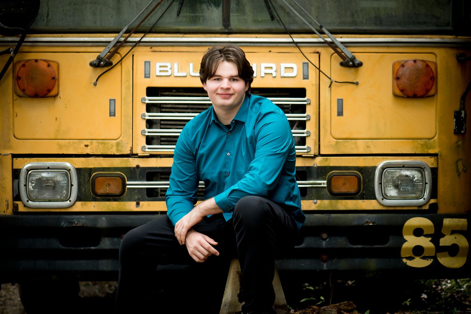 Portrait series against vintage yellow school bus with industrial styling.
