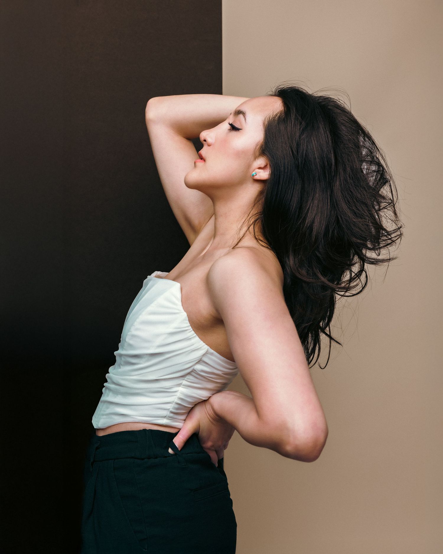 Artistic portrait series showing dramatic poses against a neutral background.