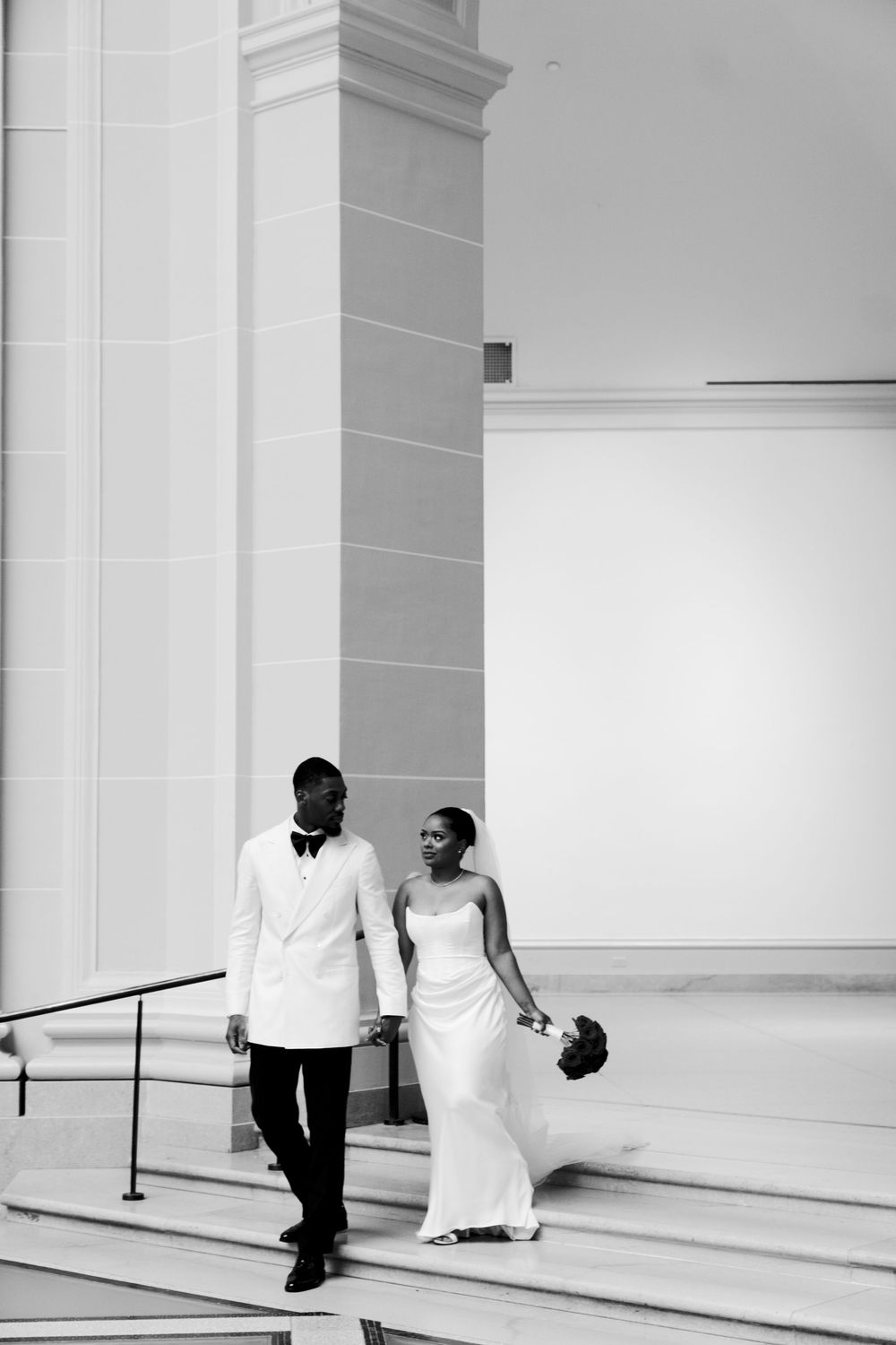 Minimalist black and white wedding photography in modern architectural setting.