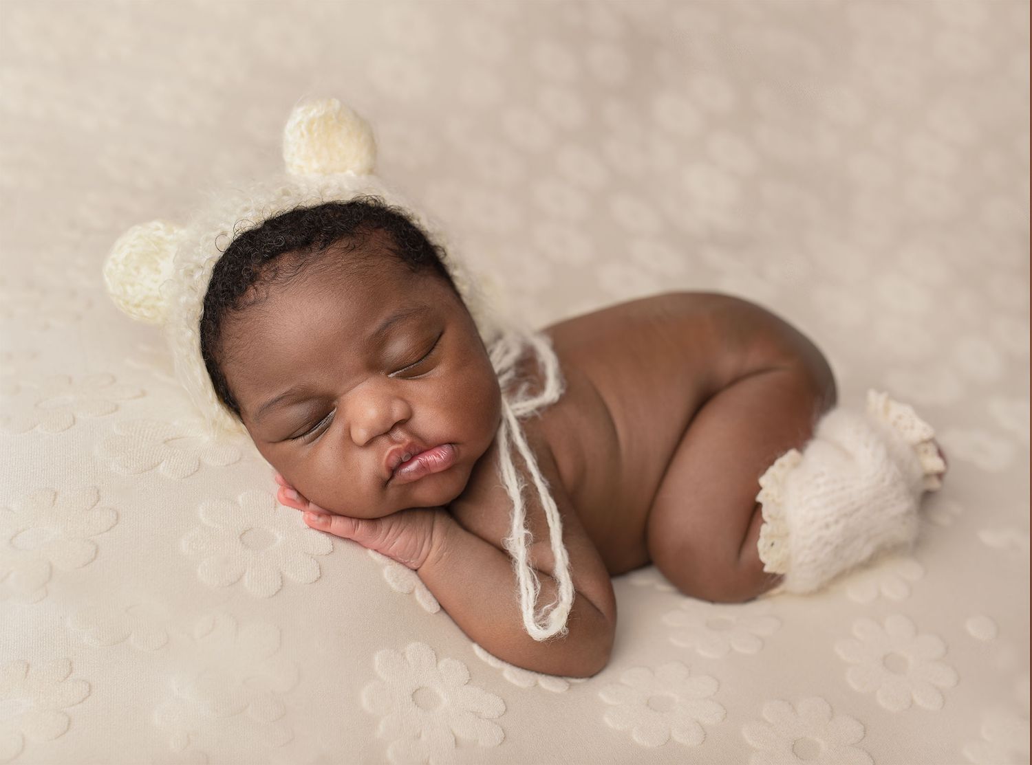 Sleeping newborn baby posed on soft blue backdrop with dreamy clouds in professional portrait setting. Oban newborn Photographer.