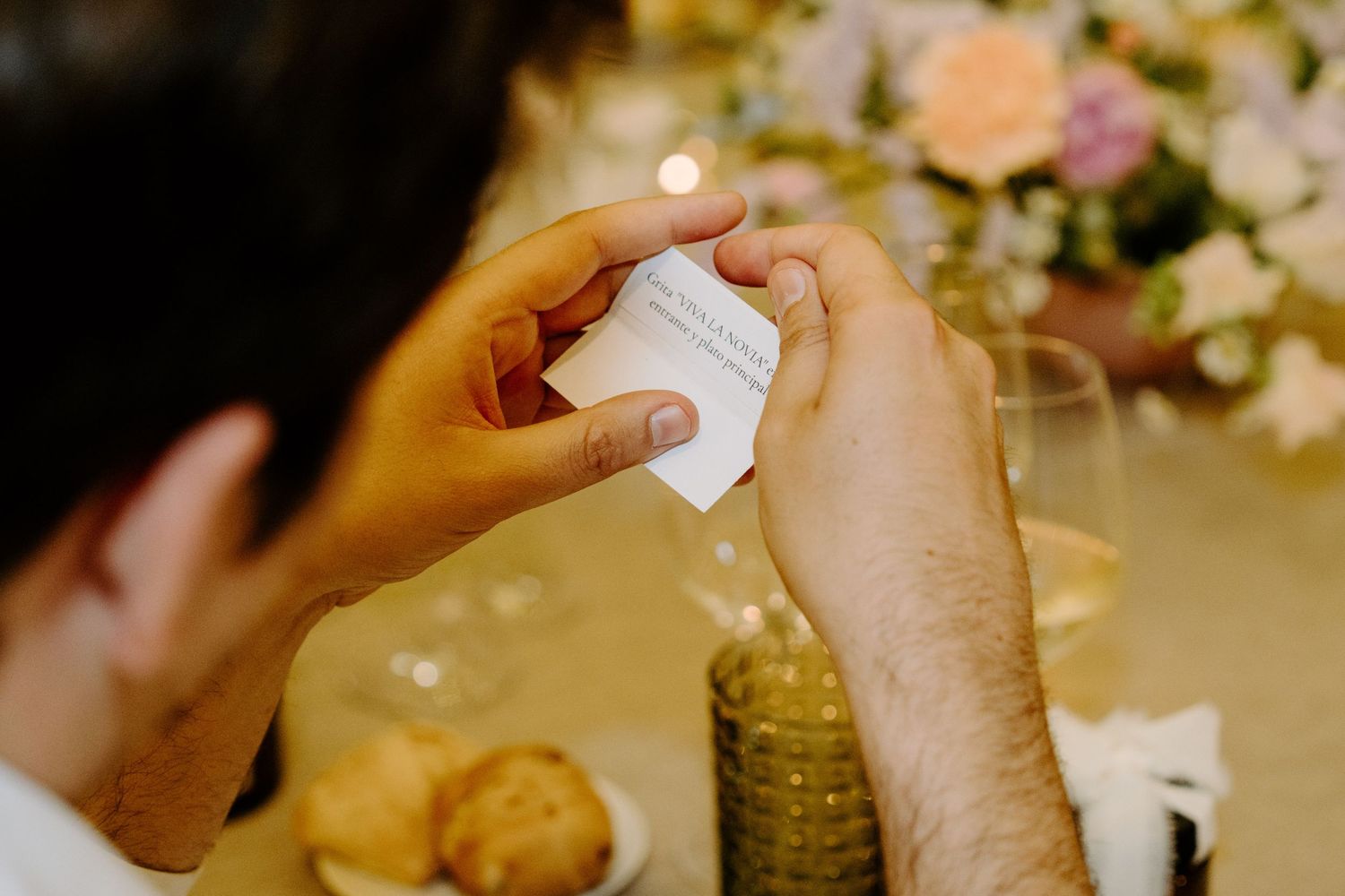 Wedding guests enjoying toasts and conversation at an elegantly decorated reception dinner table.