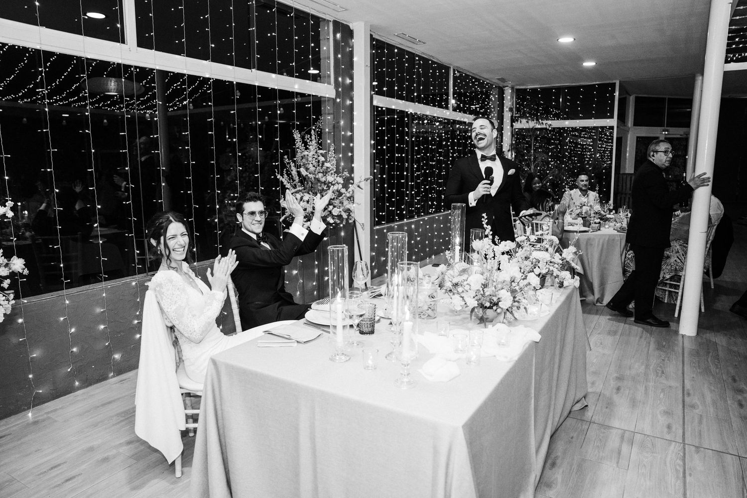 Wedding reception venue with dramatic ceiling-to-floor fairy light curtains creating a magical ambiance.