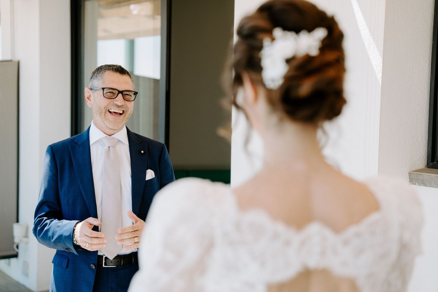 Wedding photography session in a bright indoor setting with formal attire.