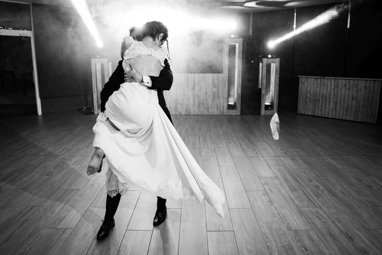 Black and white photo sequence of a ballroom dance dip on a polished floor.