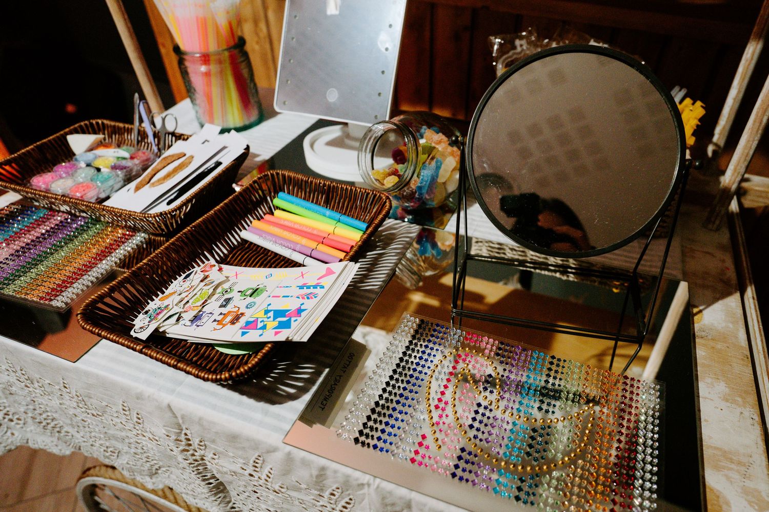 Art supplies and crafting materials spread across a wooden table surface.