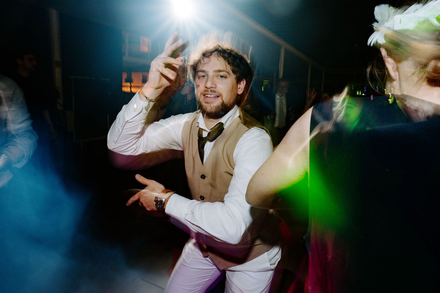 Wedding reception dance floor with dramatic lighting and festive atmosphere.