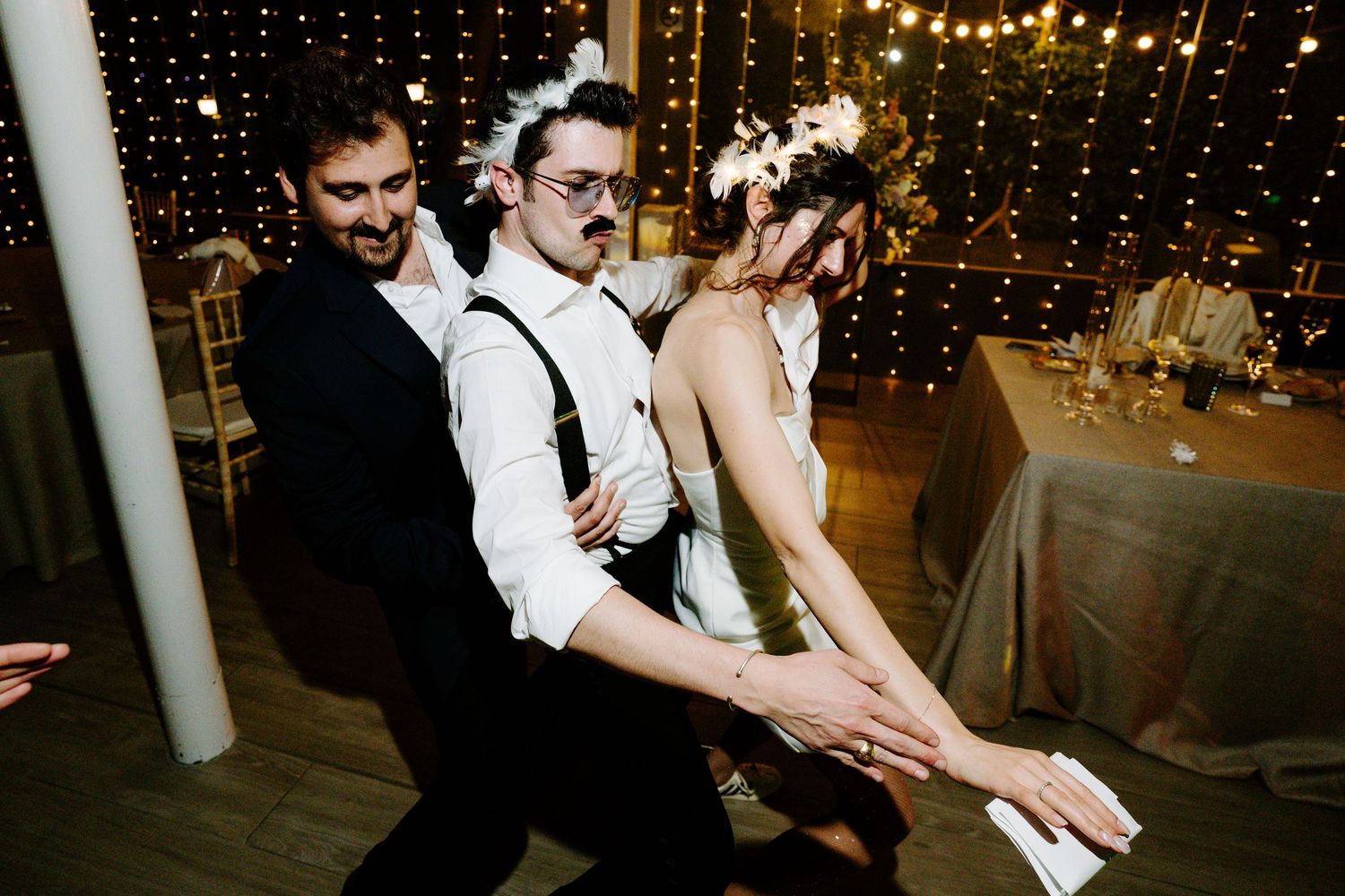 Wedding reception dance floor with string lights creating a magical atmosphere.