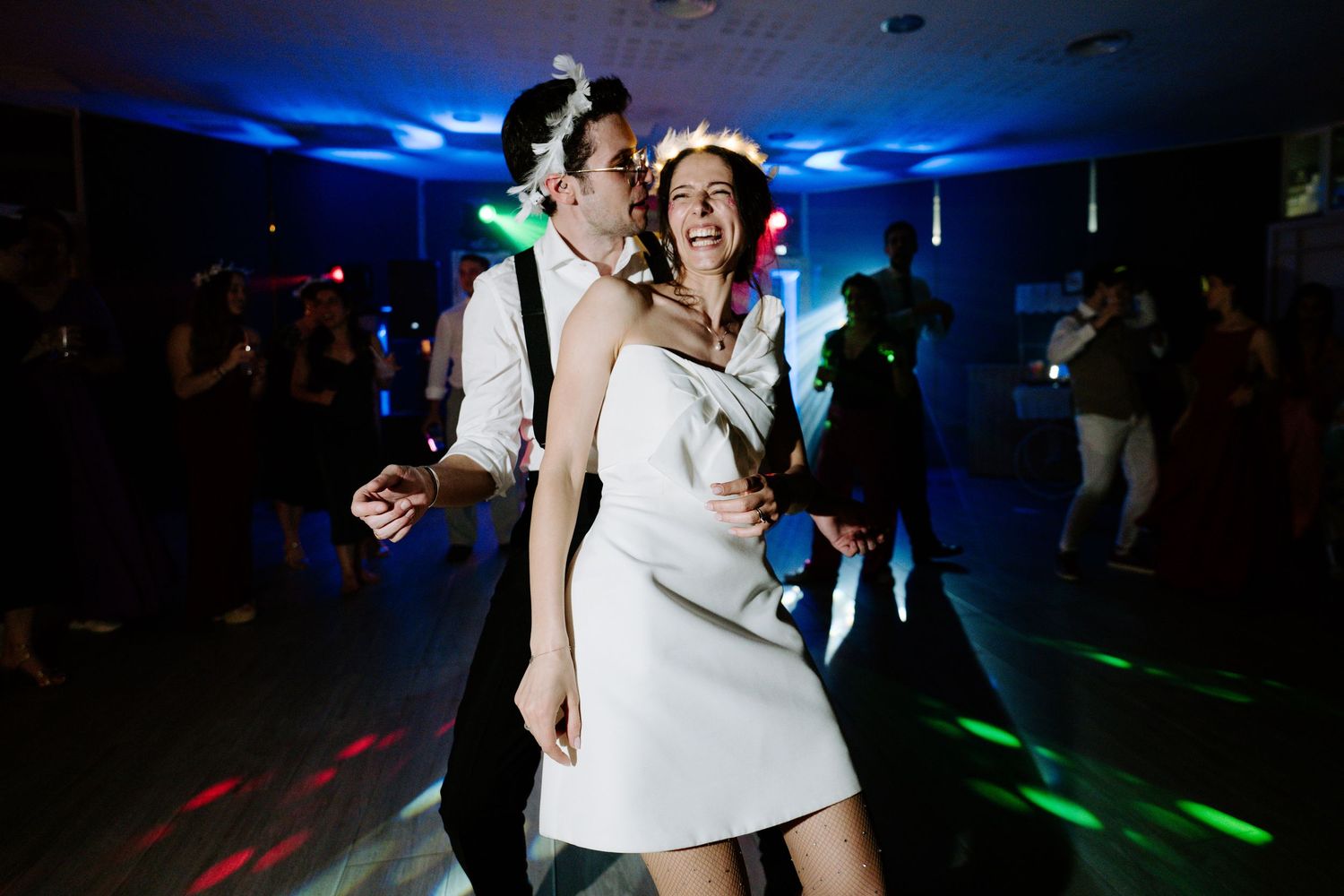 Wedding reception dance floor with blue lighting and festive atmosphere.