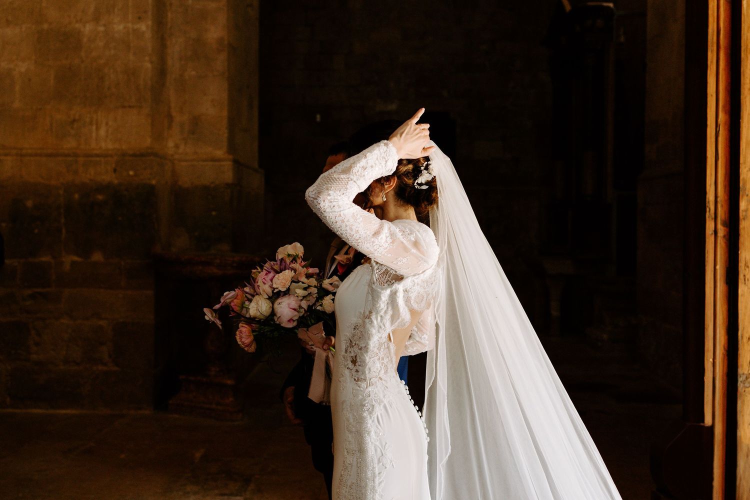 Elegant wedding celebration in ornate historic venue with warm lighting and decorative details.