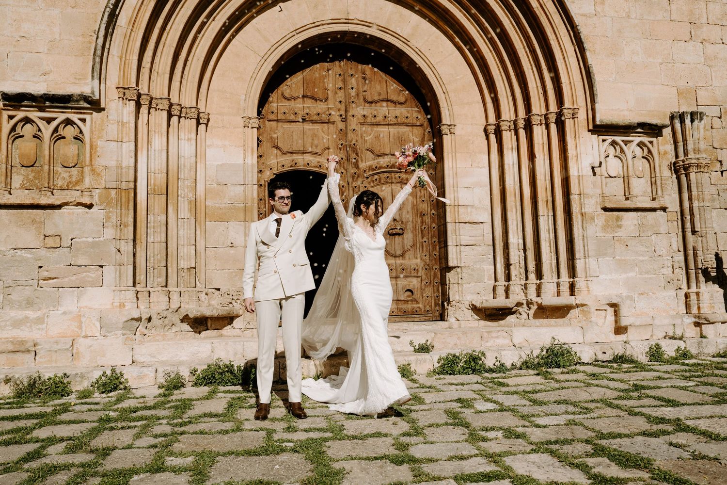 Romantic wedding photo sequence outside historic church entrance.