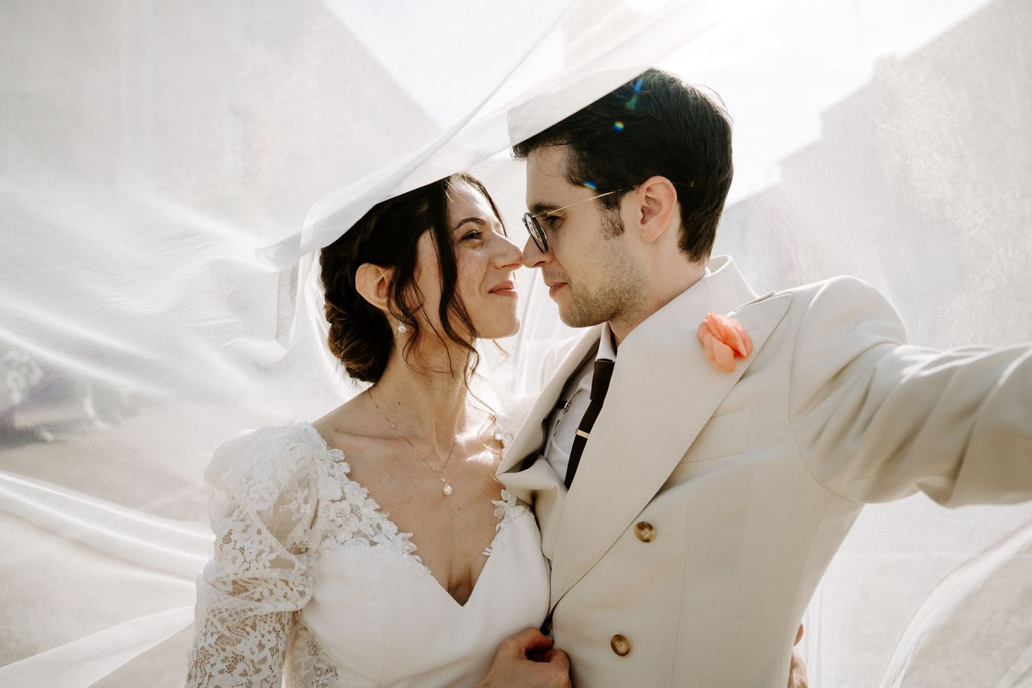 A romantic wedding moment captured in black and white against a bright background.