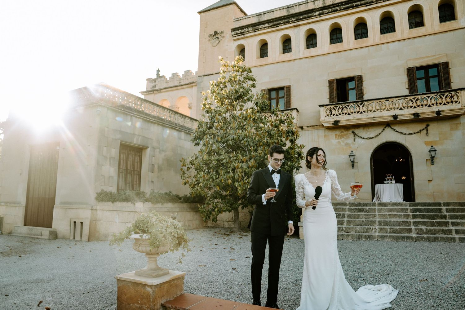 Elegant outdoor wedding venue with Spanish colonial architecture at sunset.