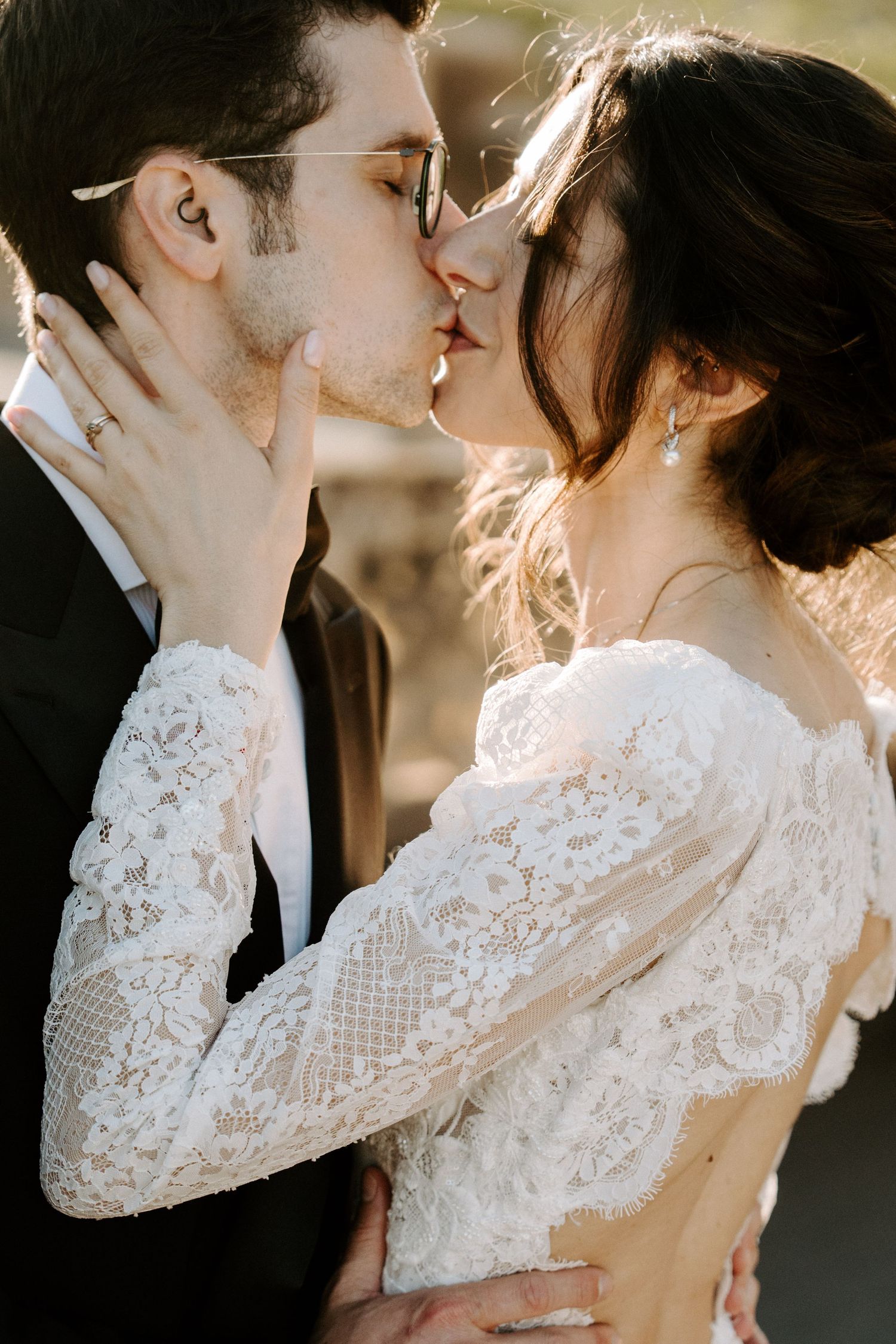 Romantic wedding portrait showing intimate moment between newlyweds at golden hour.