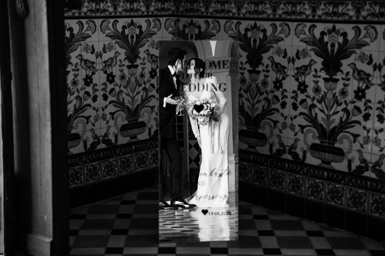Ornate black and white damask wallpaper pattern in an elegant interior space.
