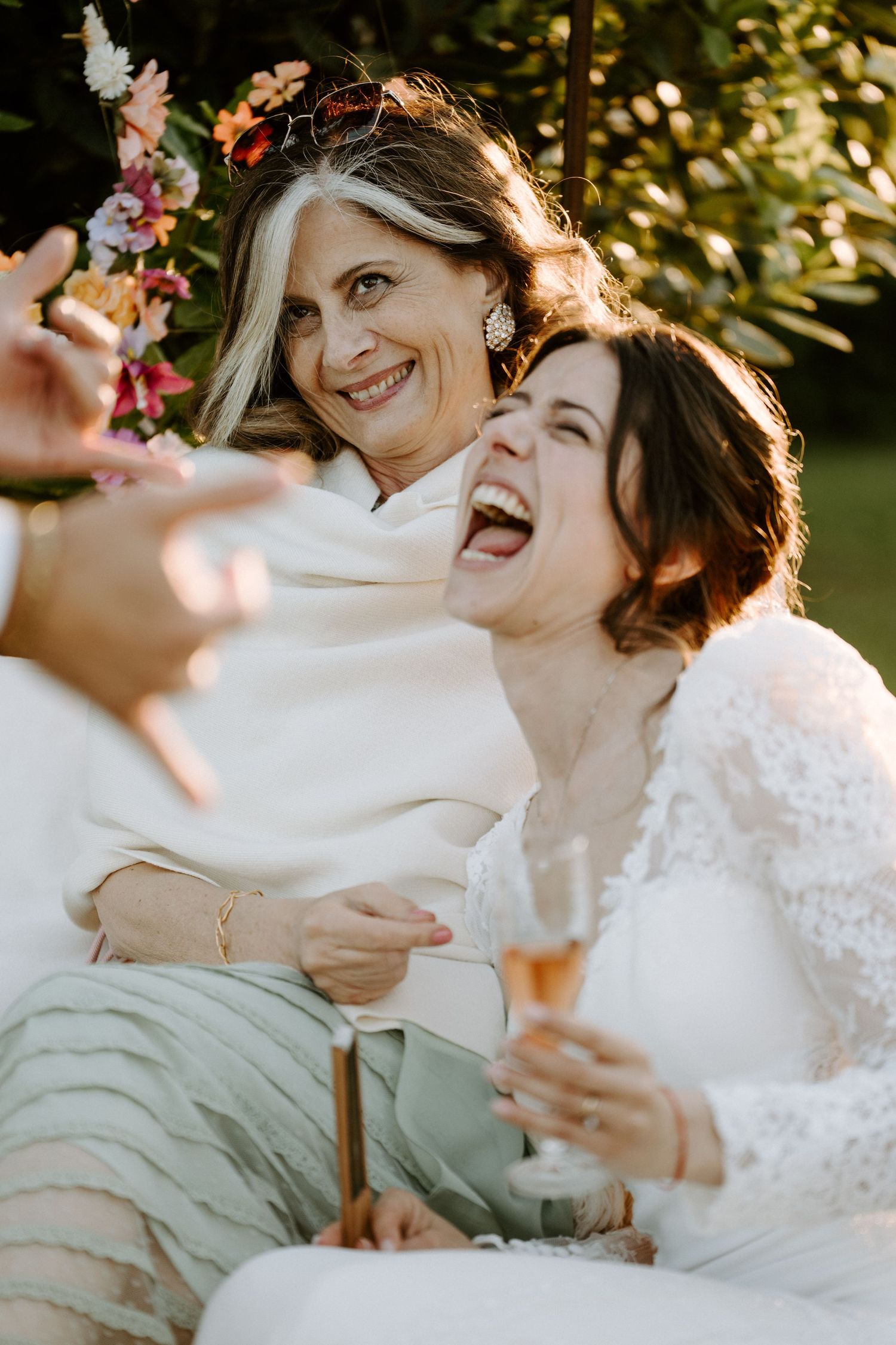 Joyful moments shared between wedding guests during outdoor celebration.