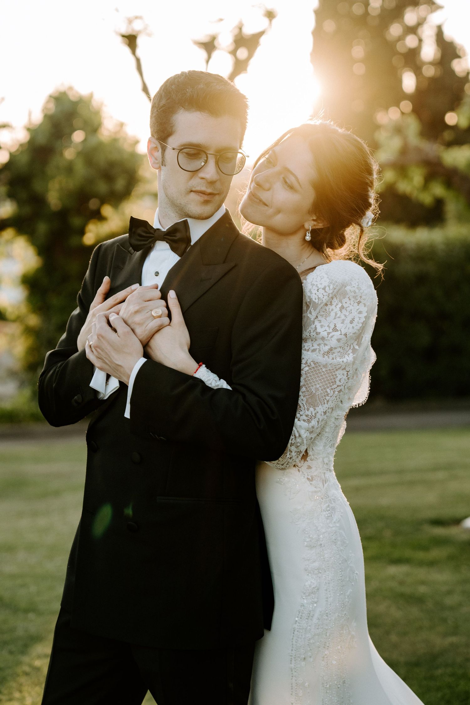 Newlyweds share an intimate moment during golden hour photography session outdoors.