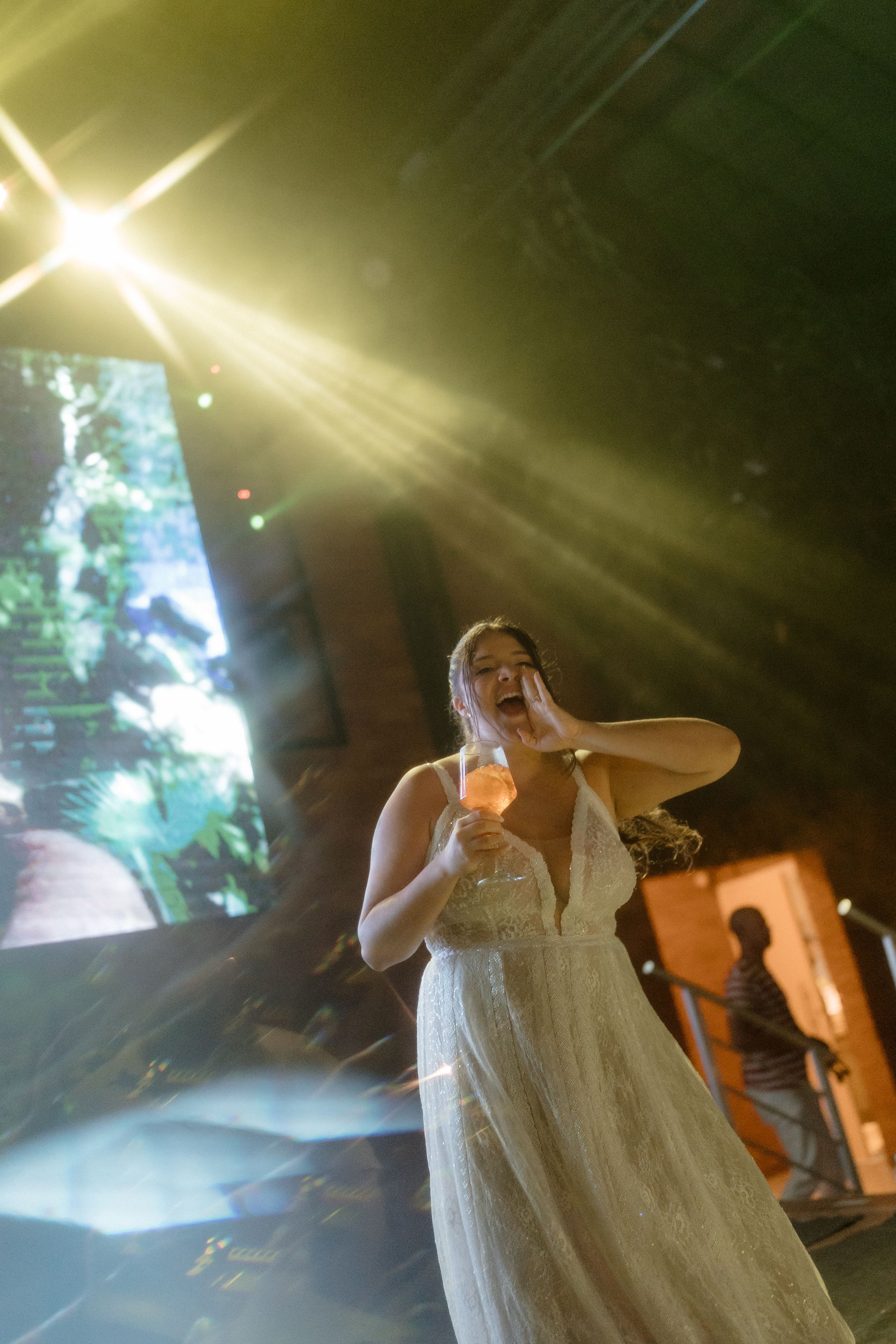 Ethereal wedding scene with dramatic sunburst lighting and misty atmosphere.
