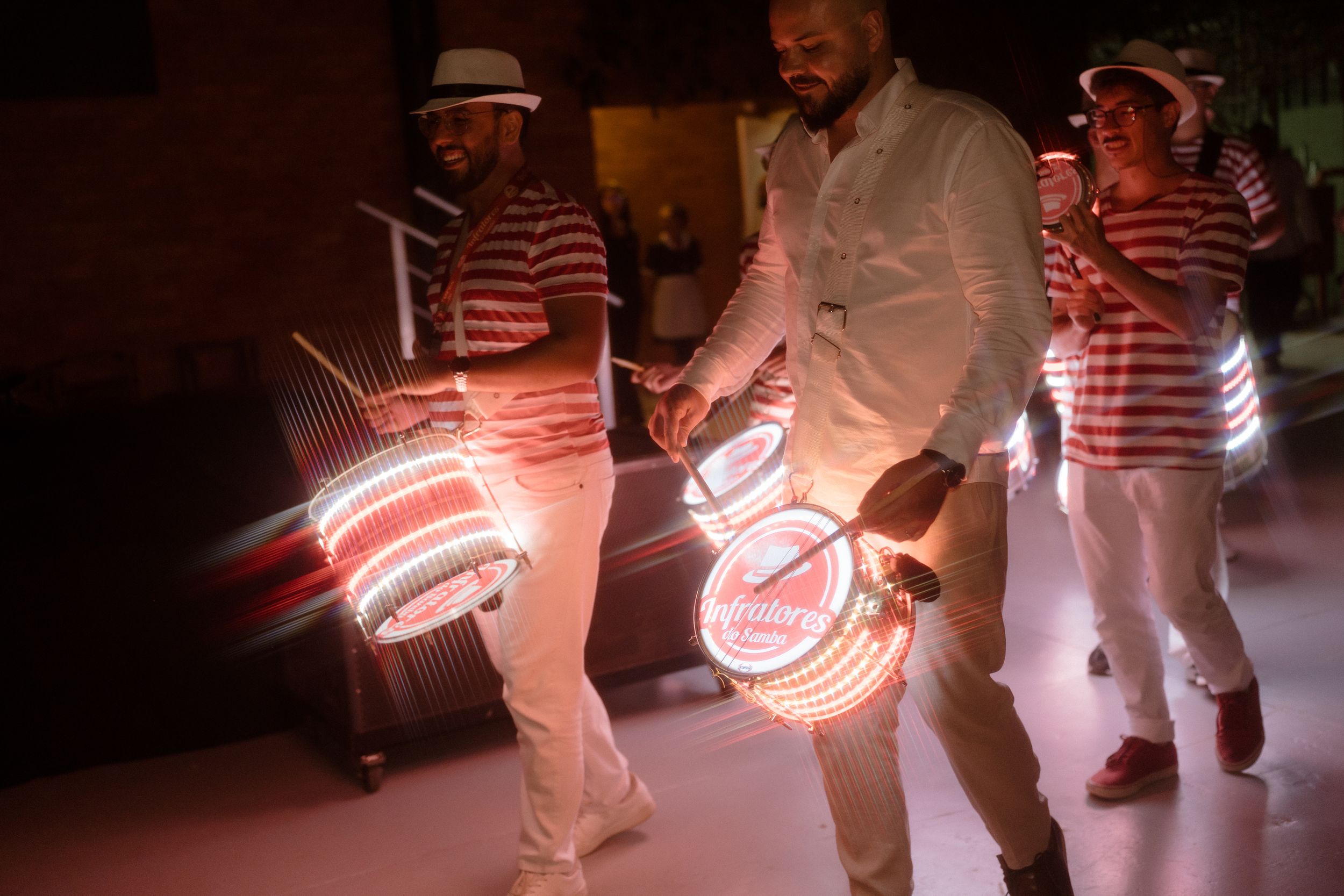 Illuminated dancers create motion trails with glowing props during a nighttime performance.