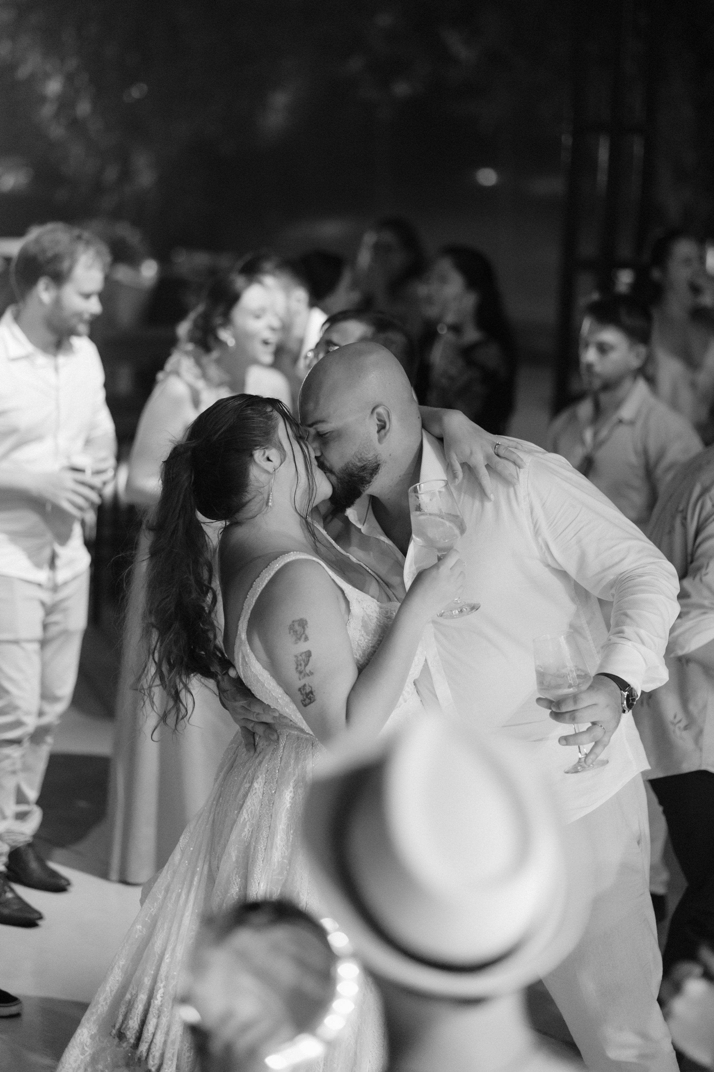 Wedding reception dance floor filled with couples in formal attire.
